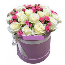 Arrangement of white and pink roses in a hat box